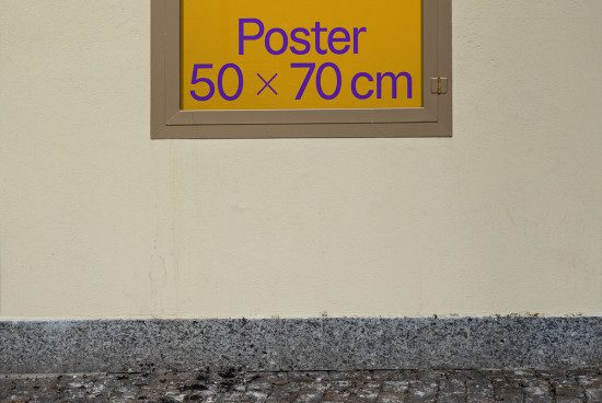 Wall-mounted poster mockup in urban setting, 50x70 cm size indicator, visible frame, ideal for outdoor advertising design preview.