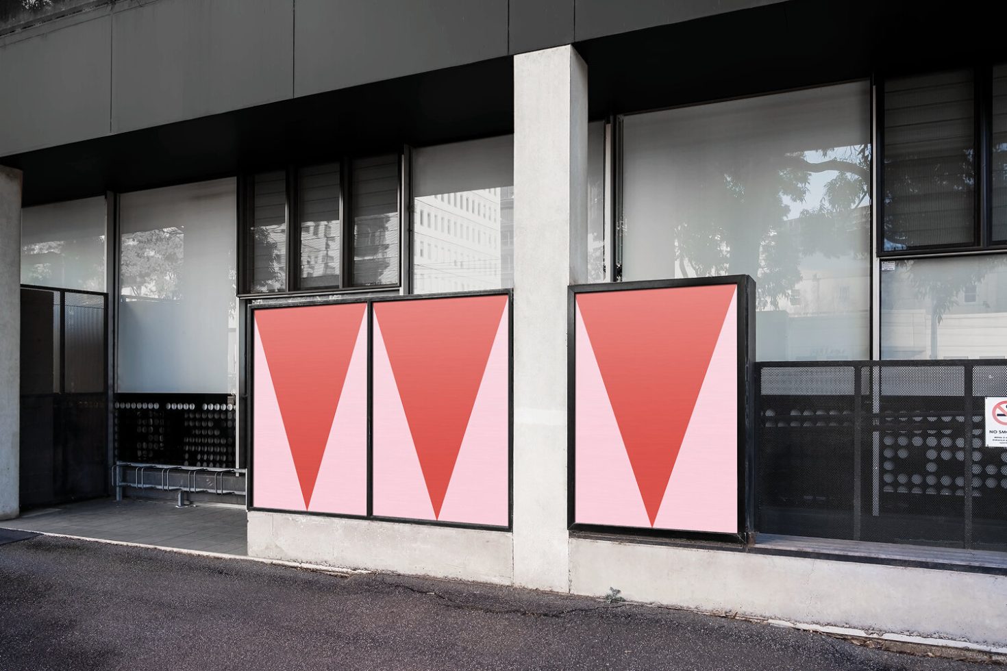 Urban outdoor poster mockup on a modern building's facade, showcasing bold geometric graphics for impactful advertising designs.