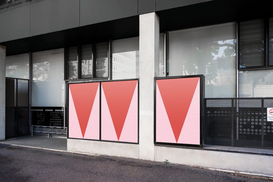 Three framed lightbox posters with coral pink triangle gradients on building corner