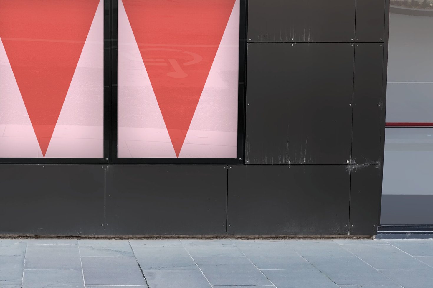 Red and white geometric building facade mockup with modern design, ideal for showcasing outdoor advertising graphics and branding elements.