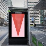 Urban billboard mockup with a red and pink design poster in a street setting, surrounded by modern architecture, ideal for advertising and graphic display.