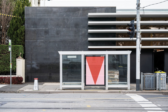 Urban bus stop mockup with large advertisement space, clear glass, and modern design elements, ideal for presenting outdoor graphics and posters.