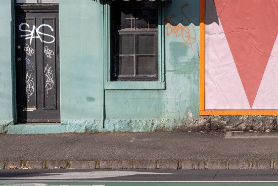 Urban street wall with graffiti and contrasting colors, ideal for textures, backgrounds, or mockups in design projects.
