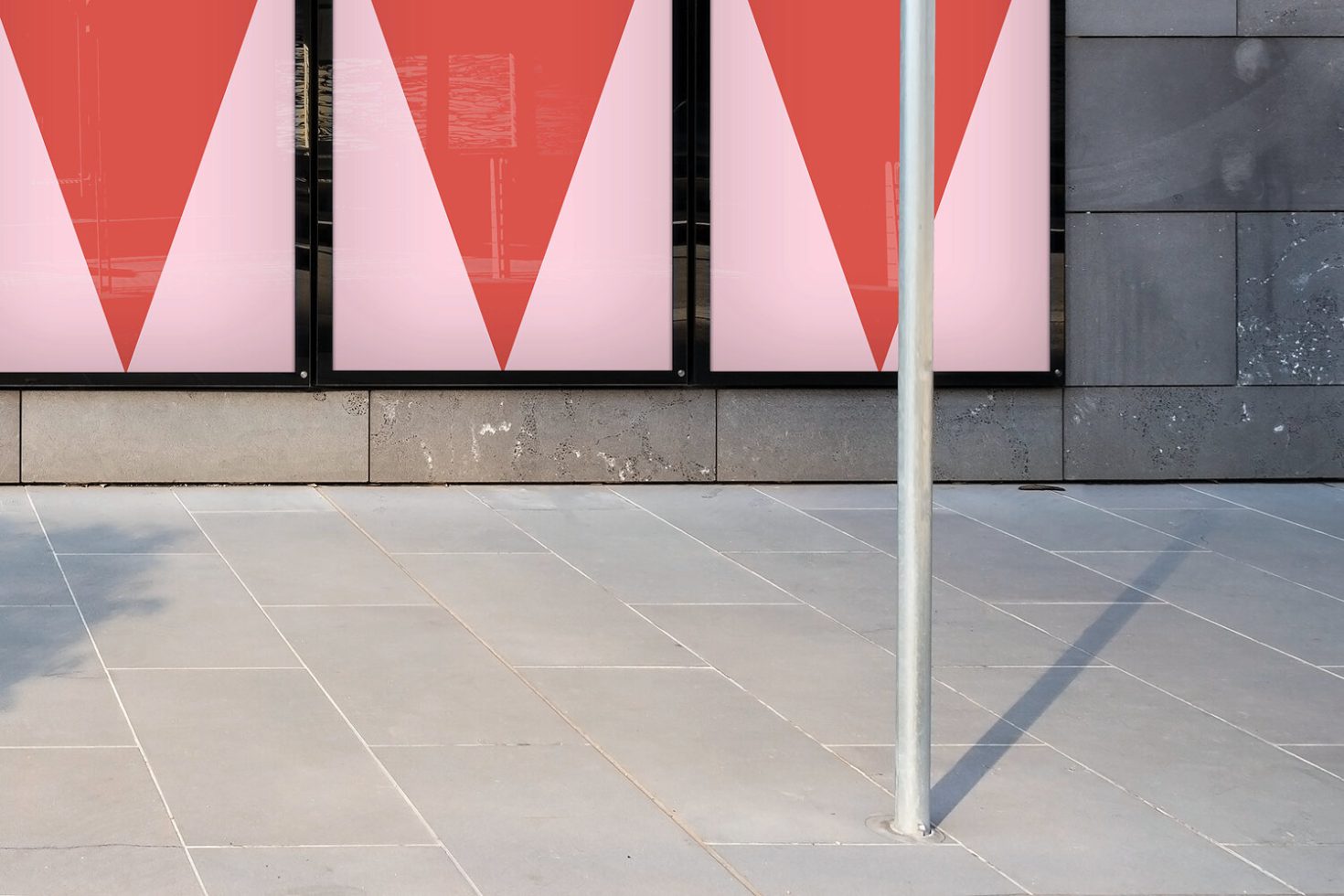 Modern storefront mockup with vibrant red and pink window graphics, urban setting for advertising designs, product showcases for designers.