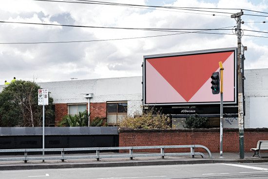 Outdoor billboard mockup with a red geometric design template, street view for realistic advertising presentations. Graphic designers' urban mockup asset.