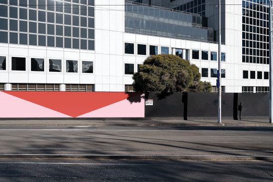Urban building exterior mockup with shadow overlay and red geometric shapes, graphic design, editable template for advertising display.