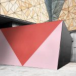 Modern building exterior with geometric facade and blank red wall mockup for marketing design presentations, urban architecture background.