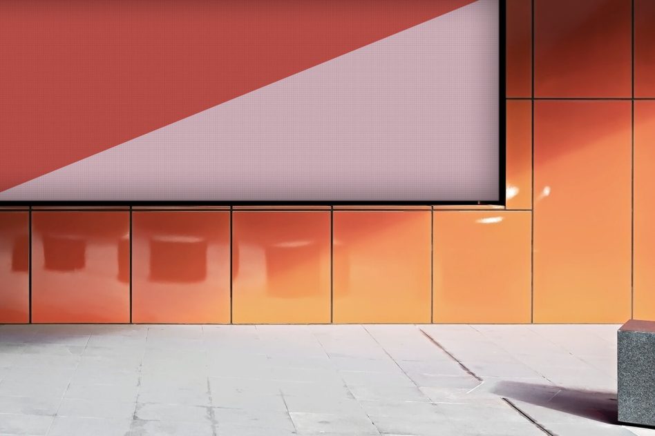 Color gradient billboard with red shape over modern glass storefront