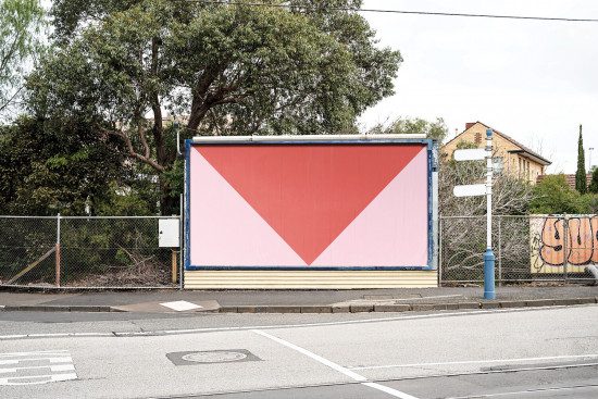 Empty urban billboard mockup on a roadside with a red background and a white downward arrow, ready for advertising graphic design.