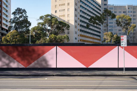 Urban scene with a vibrant red and pink graphic wall design, street view, modern cityscape, architecture backgrounds, shadow patterns.
