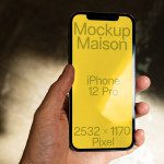 Hand holding iPhone 12 Pro mockup with yellow screen, resolution details, ideal for app design presentation, digital asset for UI designers.