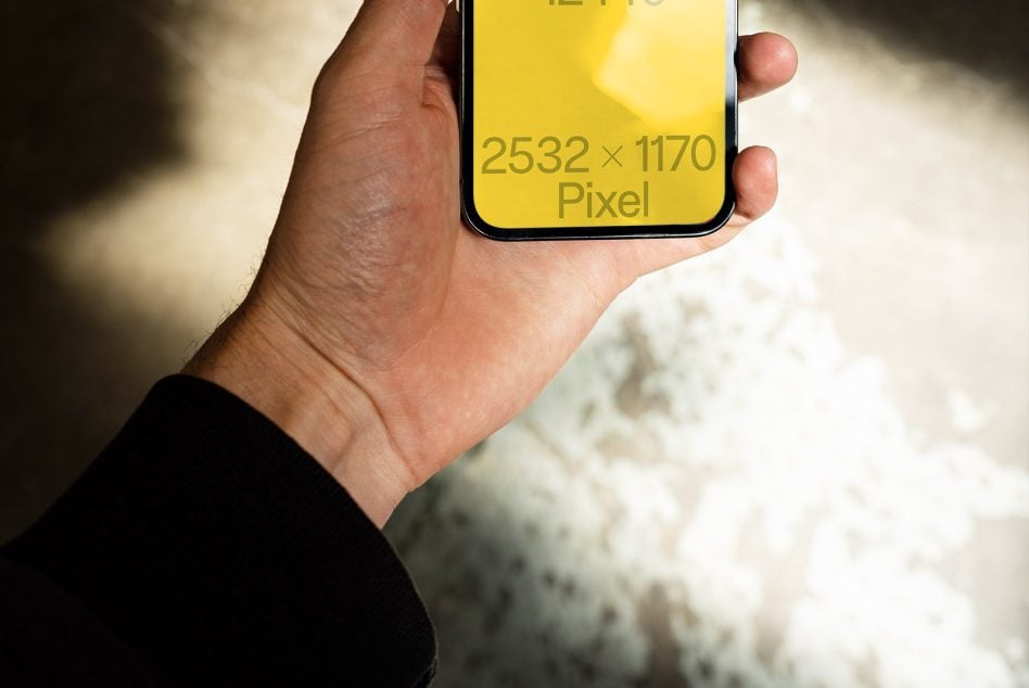 Close up of iPhone 12 Pro mockup in hand, yellow screen, bright sunlight