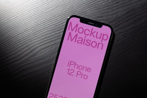 iPhone 12 Pro mockup on dark textured surface, showcasing screen design, ideal for presentations, digital asset for designers.