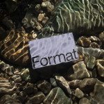 Paper with word Format under clear water over riverbed with light refraction, ideal for realistic mockup graphic asset.