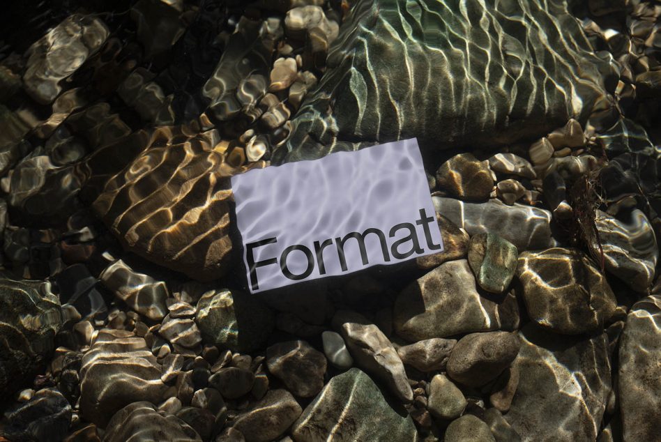 Paper with word Format under clear water over riverbed with light refraction, ideal for realistic mockup graphic asset.