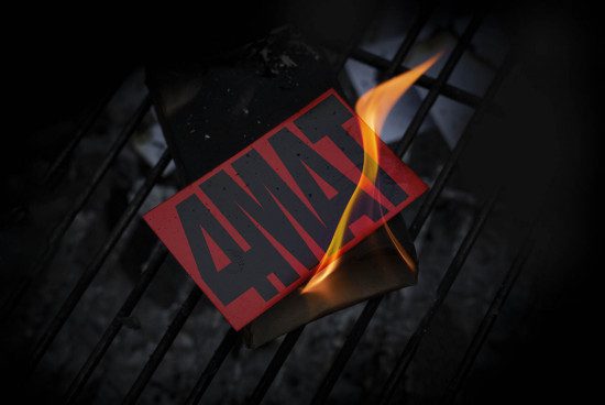 Dark dramatic mockup of a burning card with red bold text on metal grate, suitable for graphic presentations and design elements.