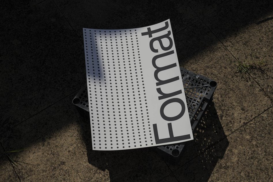 Curved white sheet showing large sans-serif text vertically aligned with dots pattern