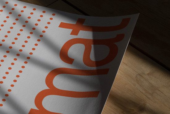 Print design mockup featuring bold typography and pattern, lying on a wooden surface, depicting shadow play for a realistic presentation.