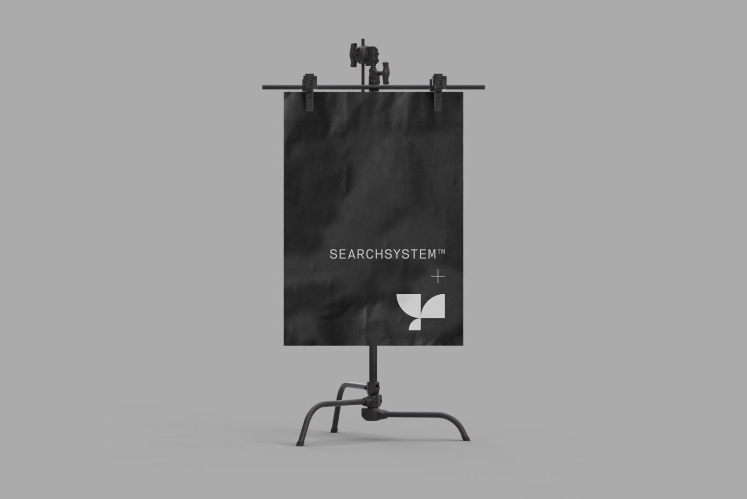 Easel mockup displaying black poster with minimalist logo, ideal for designers to showcase branding graphics in a professional setting.