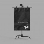 Easel mockup displaying black poster with minimalist logo, ideal for designers to showcase branding graphics in a professional setting.
