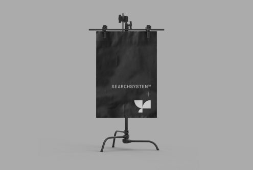 Easel mockup displaying black poster with minimalist logo, ideal for designers to showcase branding graphics in a professional setting.