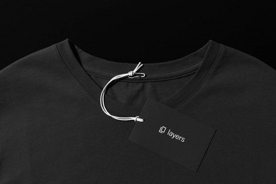 Black t-shirt mockup with a branded tag, high-quality apparel presentation, ideal for designers creating clothing graphics and logos.
