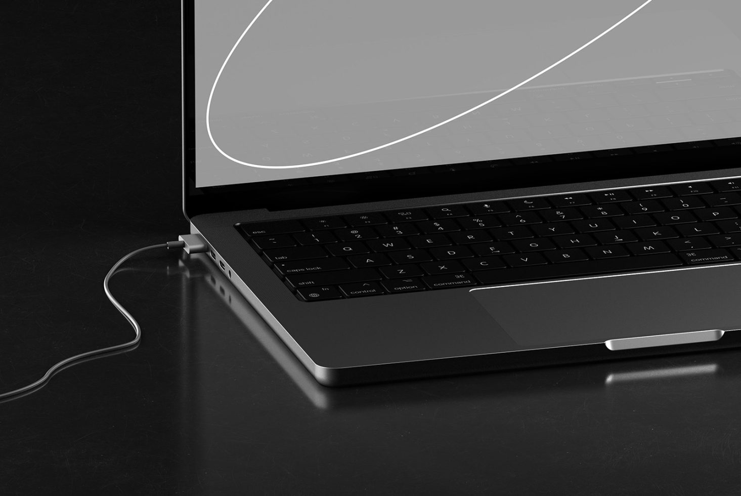 Partial view of a modern laptop with USB-C cable connection on a dark surface, ideal for tech mockups, designers digital workspace.