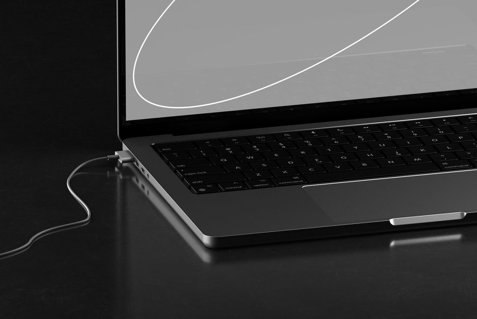 Laptop from side angle with mouse cable, gray gradient desktop wallpaper