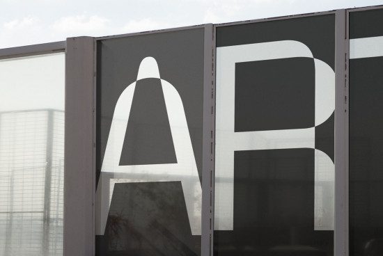 Modern typeface design on building facade, showcasing bold sans-serif lettering, ideal for graphics and font inspiration for designers.