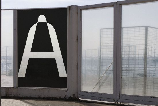 Large letter A in sans-serif font on display in urban setting for graphic design and typography mockup with river backdrop.
