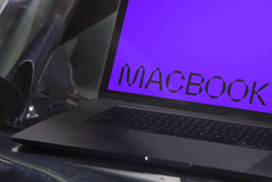 Laptop mockup with vibrant purple screen and stylish custom font logo, angled view on reflective surface, for graphic design display.