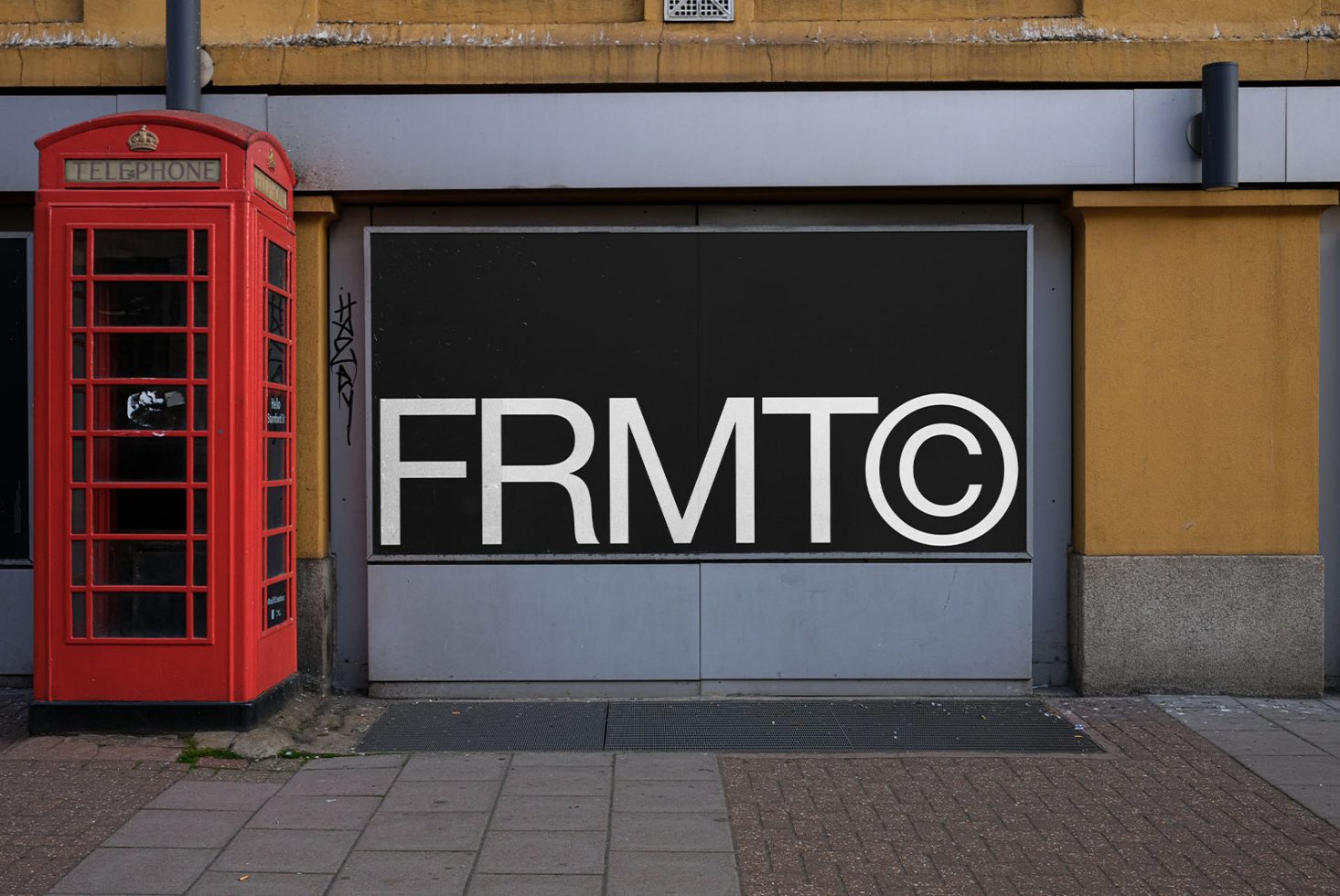 Urban street wall mockup with bold typography and copyright symbol next to classic red phone booth, perfect for branding presentations.