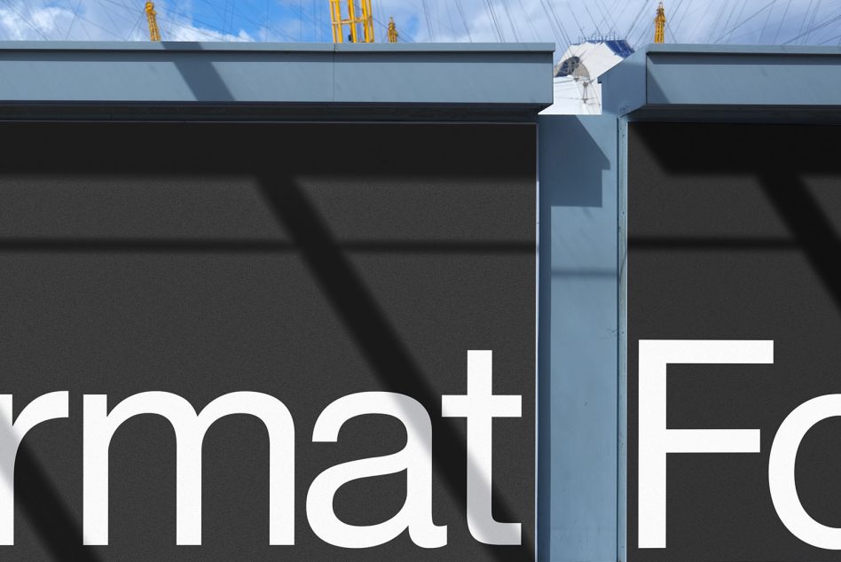 Architectural signage mockup with bold typography on building facade, clear blue sky in background, suitable for brand presentation.