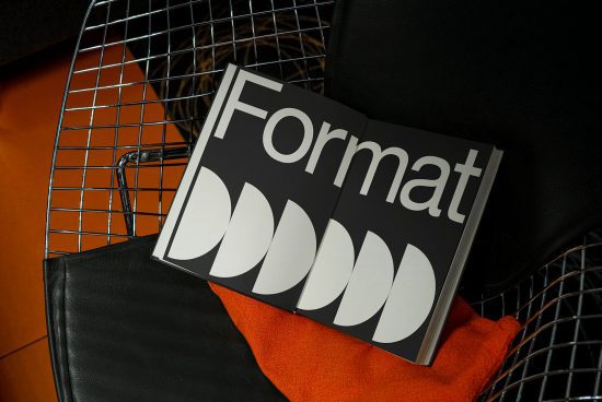 Creative monochrome book cover mockup with bold typography on an orange background, placed in a modern wire basket. Ideal for graphic design showcase.