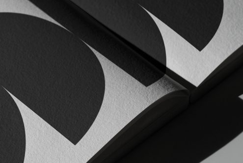 Close-up of a black-and-white graphic print mockup with elegant shadows and texture, perfect for showcasing design work.