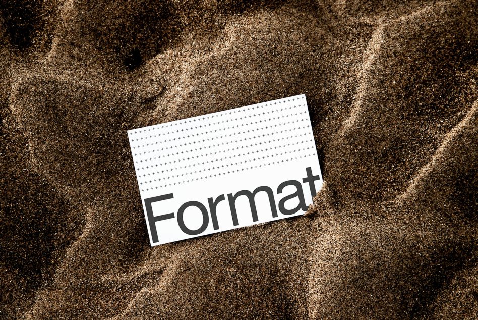Business card mockup on sandy surface with Format text in sans serif font