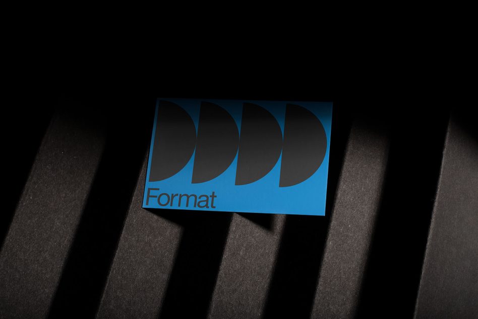 Blue business card with Format text curved shape design on dark striped surface