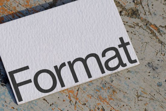 Textured paper mockup with bold font design for Format on weathered surface, ideal for presenting branding and typography assets.