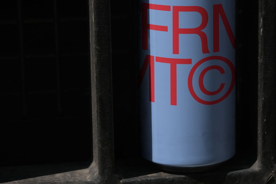 Close-up of blue can with red FRNTIC text angled in dark frame