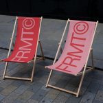 Two foldable deck chairs with bold branding ideal for mockup outdoor advertising graphics, product display or design portfolio.