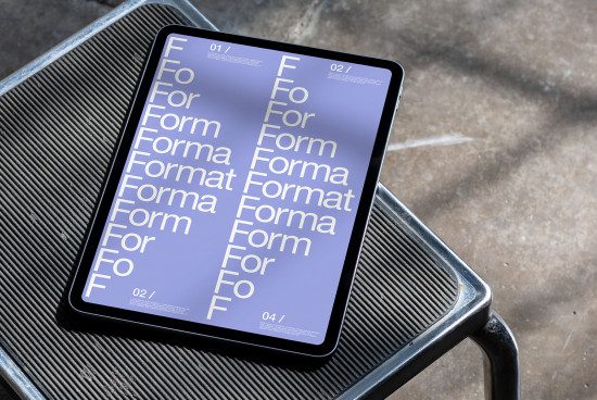 Tablet with typography design mockup on metal bench showcasing various font sizes, perfect for designers looking for digital font presentations.