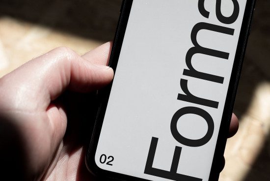 Close-up of a hand holding smartphone displaying bold font, ideal for mockup, font design, user interface, digital asset.