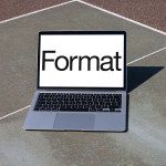 Laptop on outdoor court displaying bold 'Format' text, ideal for font preview mockups, graphic design, and digital asset templates.