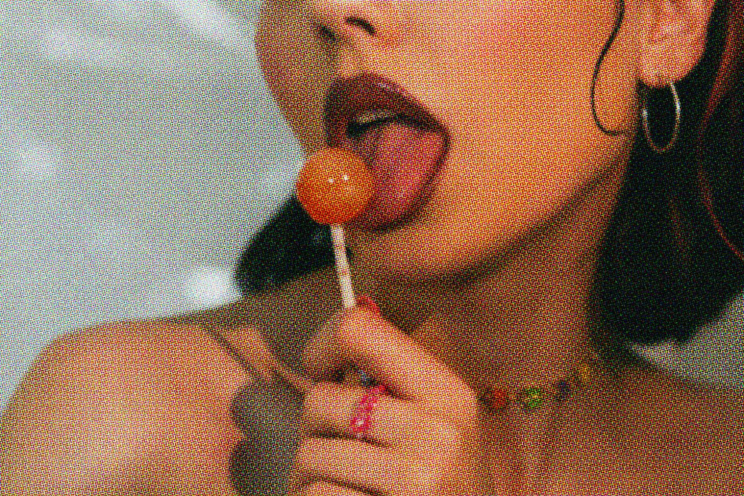 Close-up of a woman licking a lollipop, ideal for edgy fashion graphics or provocative template designs for creative projects.