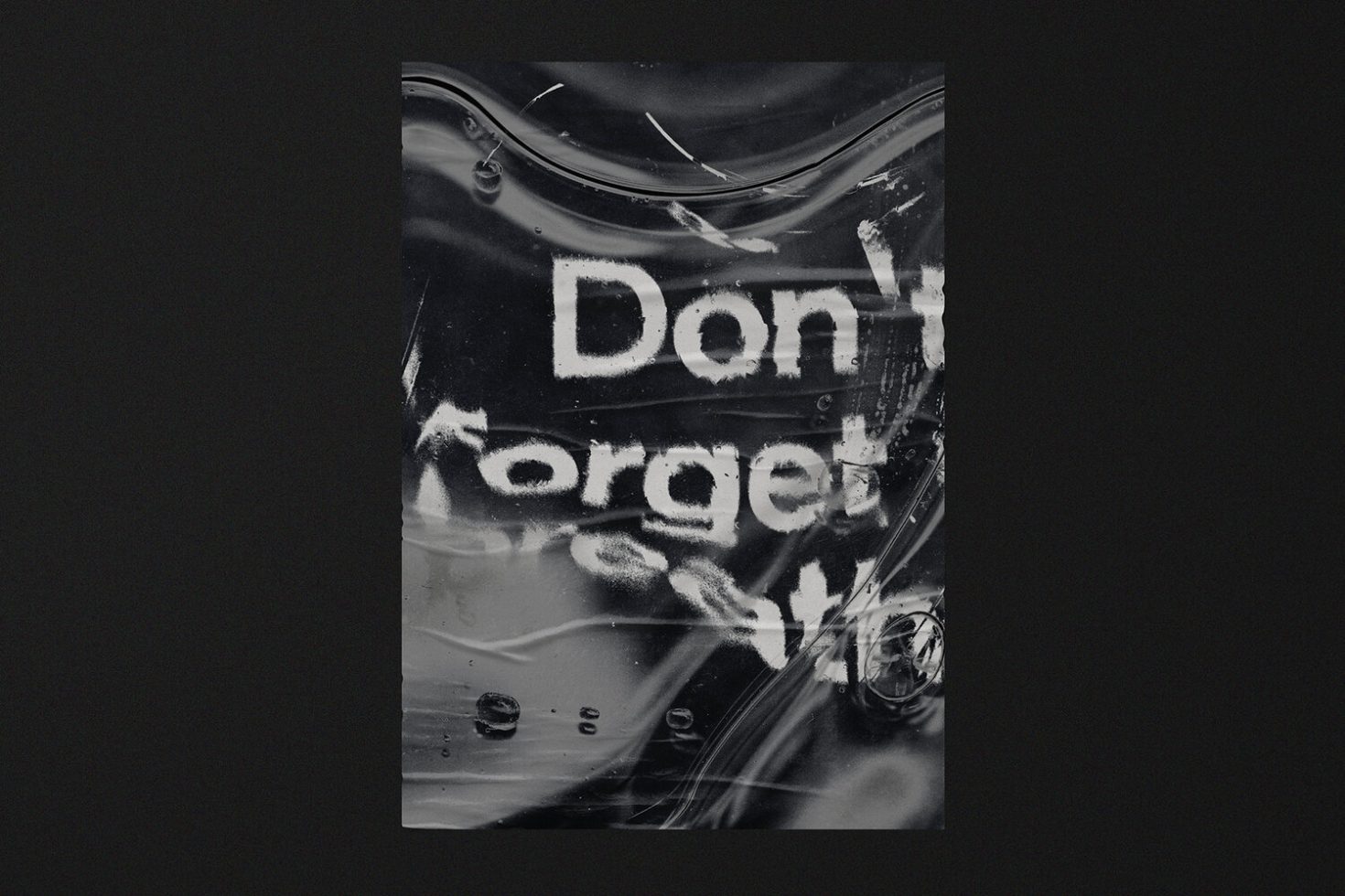 Abstract textured poster mockup with the phrase "Don't forget" visible through a distorted wet plastic surface on a dark background, for design inspiration.