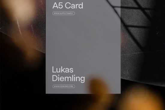 A5 card mockup with elegant font showcasing a designer's name and website, perfect for presenting branding designs.