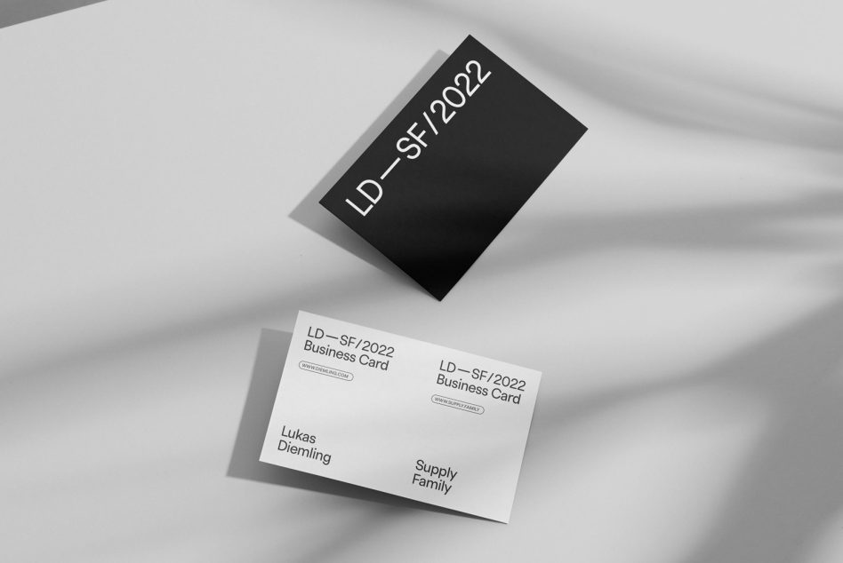 Elegant black and white business card mockup on a textured background, showcasing modern typography and design layout, ideal for presentations.