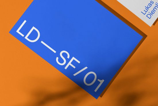 Graphic design blue business card mockup on orange background with shadow detail, layout creativity concept.