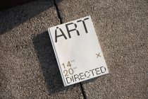 Book cover mockup on asphalt with natural sunlight casting shadow