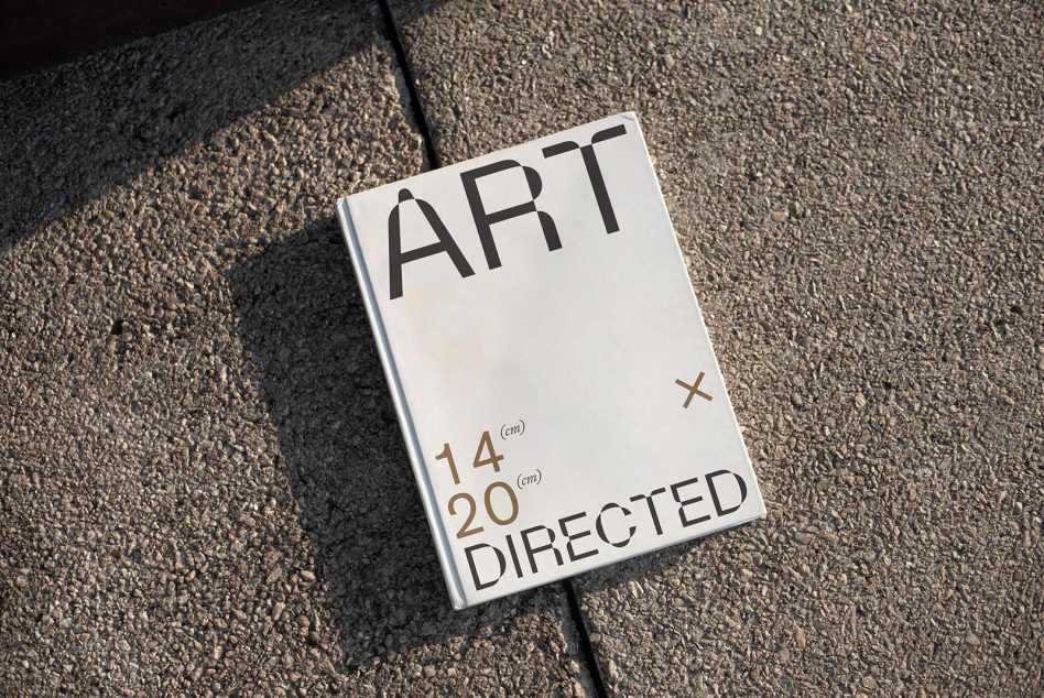 Book cover mockup on asphalt with natural sunlight casting shadow